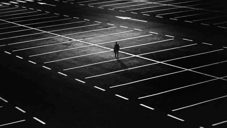 man standing on parking lot