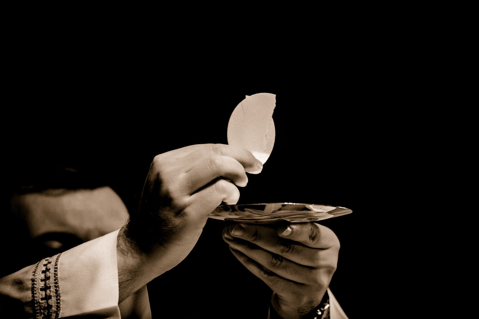 priest holding hostia