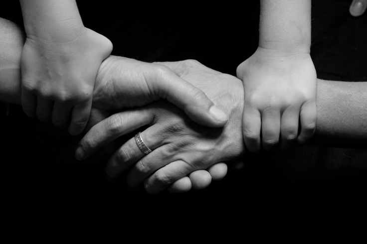 black and white connected hands love