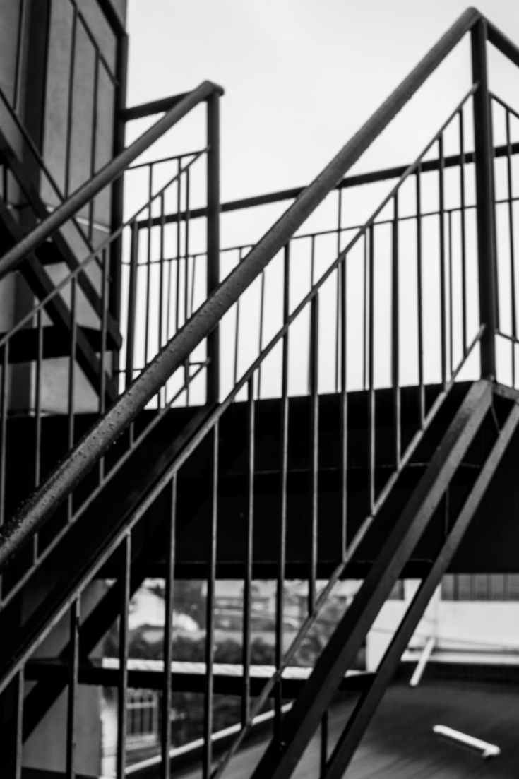 greyscale photo of metal staircase